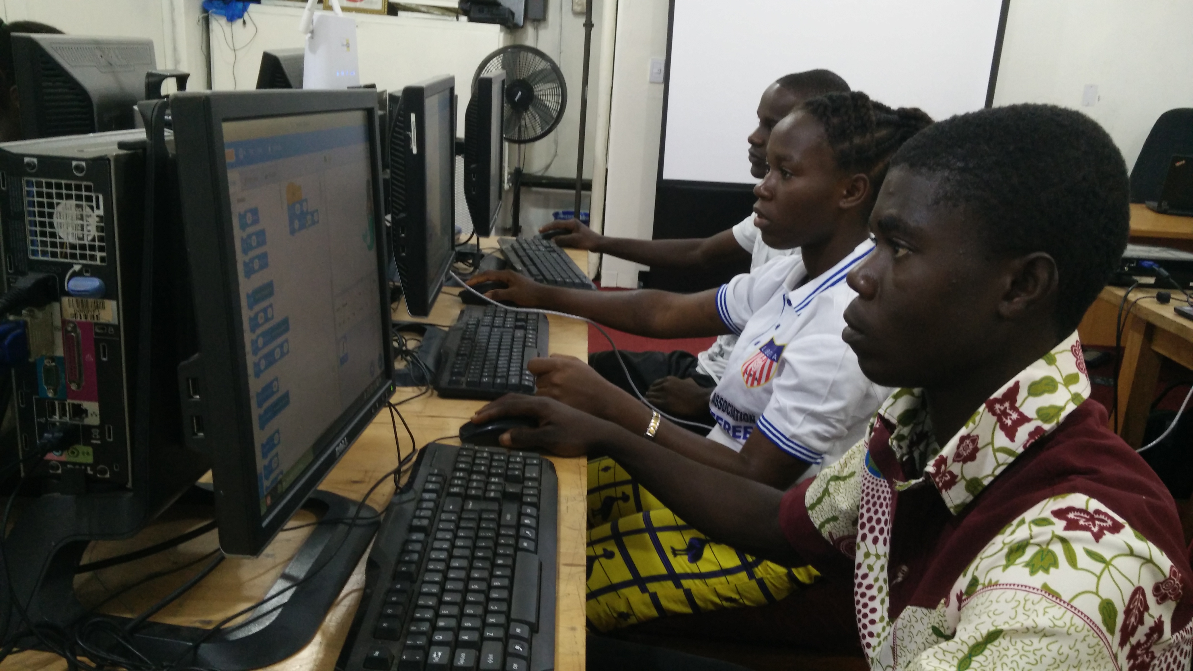 Titus, Desiree, and Abdulahi programming with Scratch